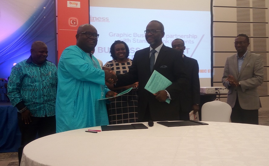 The MD of Graphic, Kenneth Ashigbey in a handshake with the MD of Mega-Choice Digital Network after the signing.